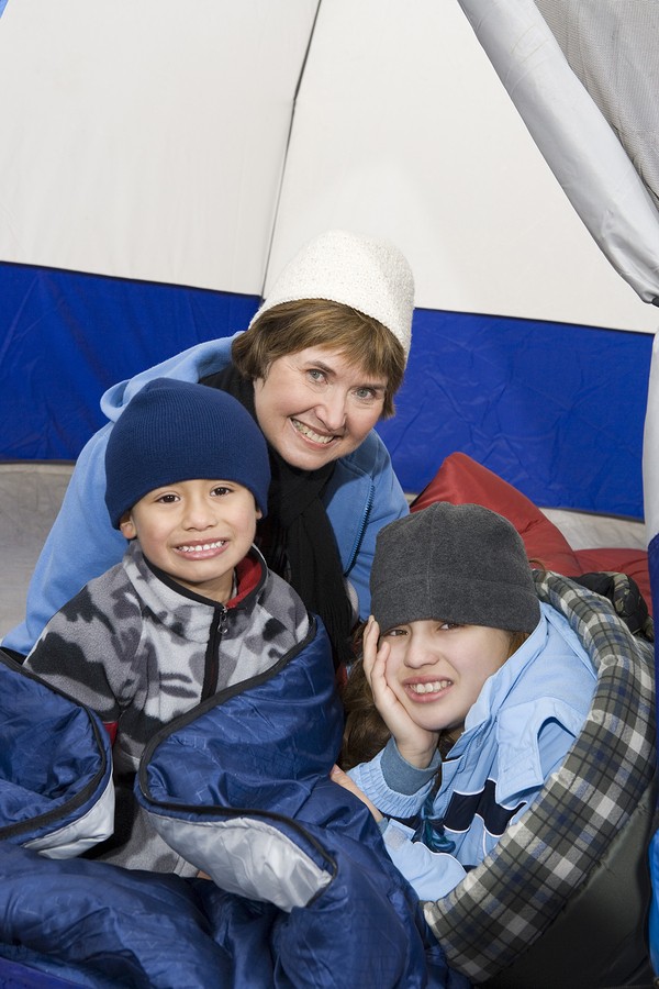 Children with grandmother relaxing in tent