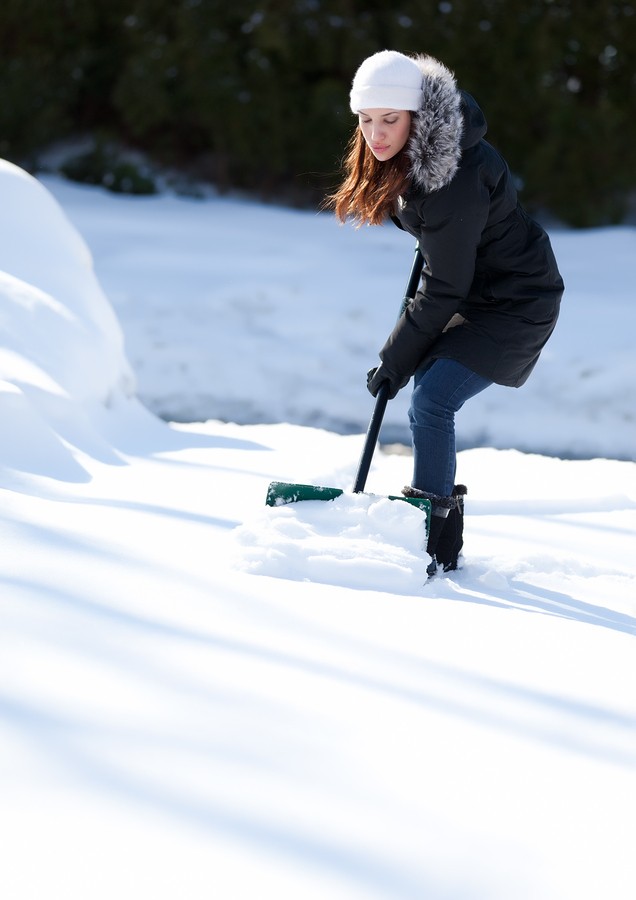 Woman Working Hard To Shovel Snow