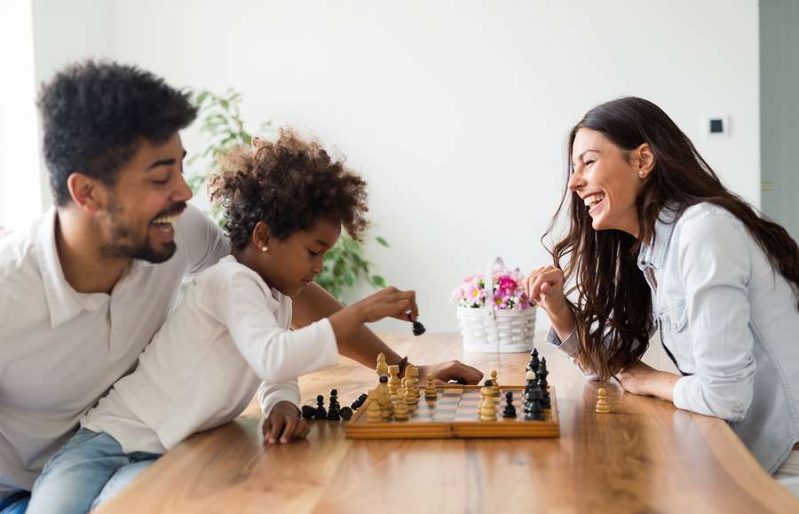 Happy family playing board games - London Drugs